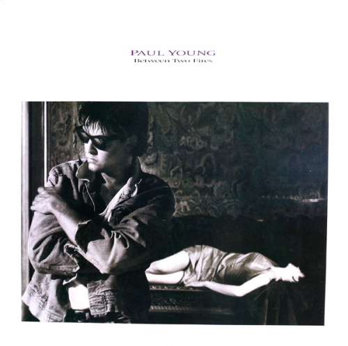 Cover Paul Young - Between Two Fires (LP, Album) Schallplatten Ankauf
